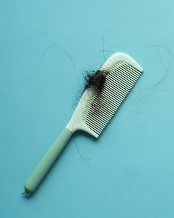 a-brush-with-lost-hair-on-table-2023-11-27-05-17-18-utc