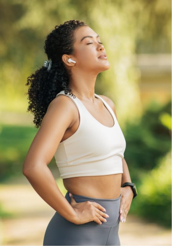 athletic-woman-standing-on-path-with-hands-on-hips-2024-06-05-01-18-15-utc