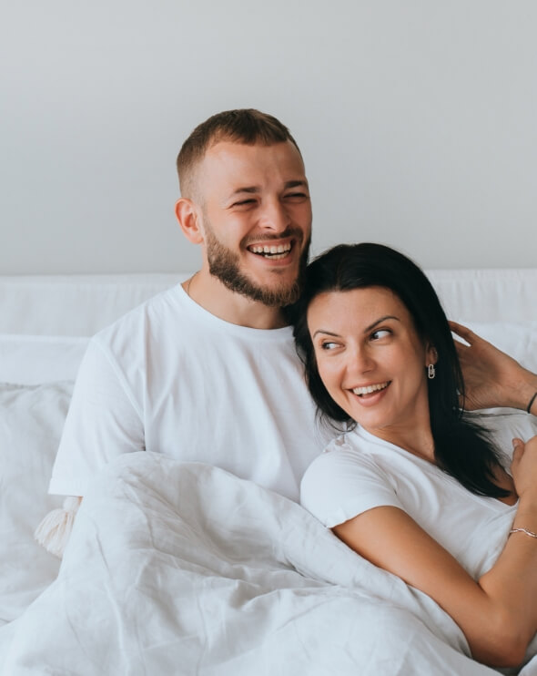 laughing-young-couple-awakening-at-new-apartment-h-2023-11-27-04-57-55-utc