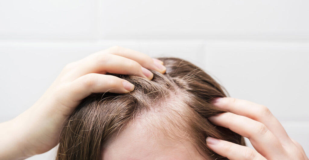 woman-touching-her-hair-close-up-on-white-tiles-ba-2025-01-10-05-32-15-utc (1)